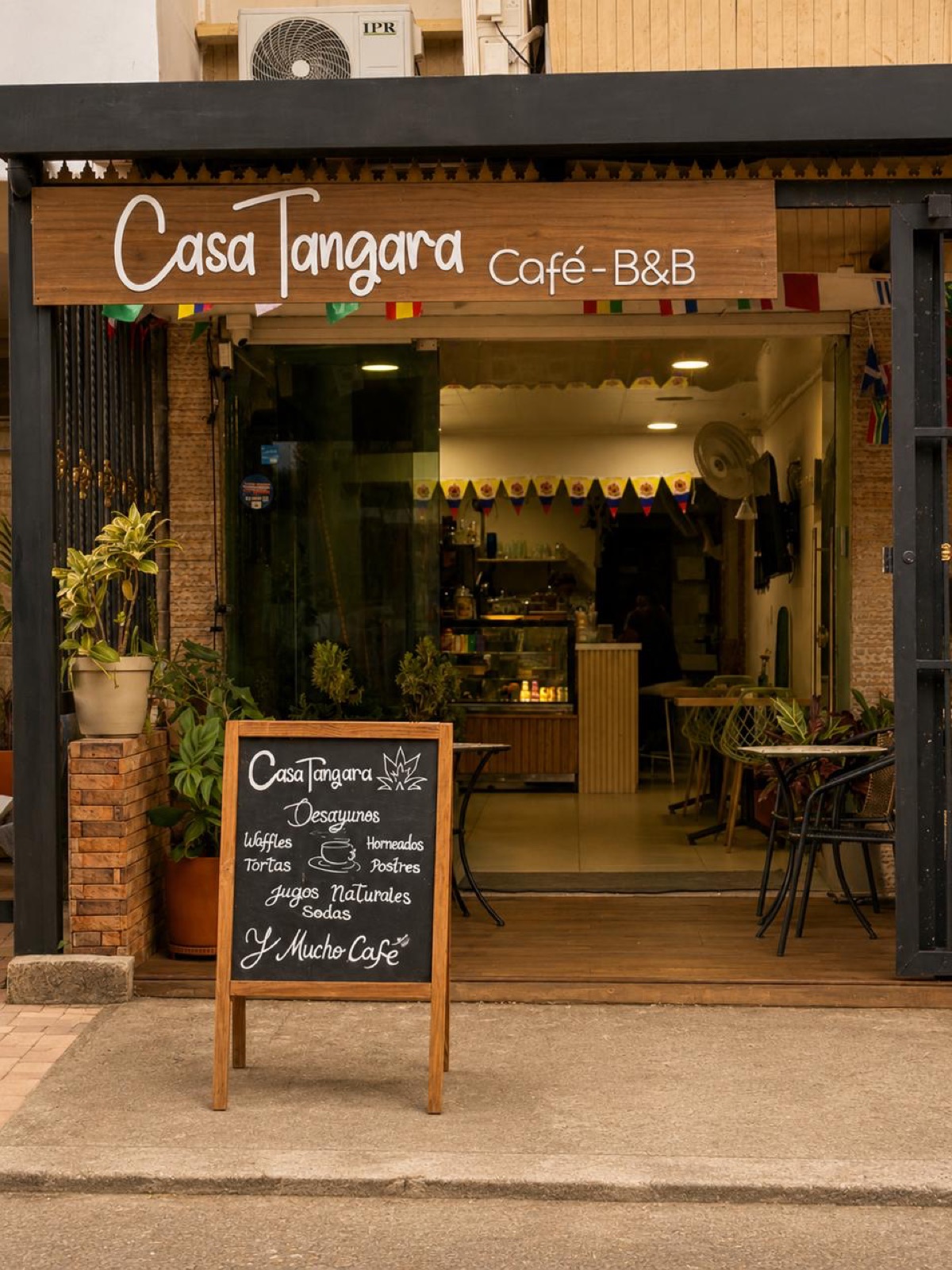 Casa Tángara café facade with chalkboard menu and plants