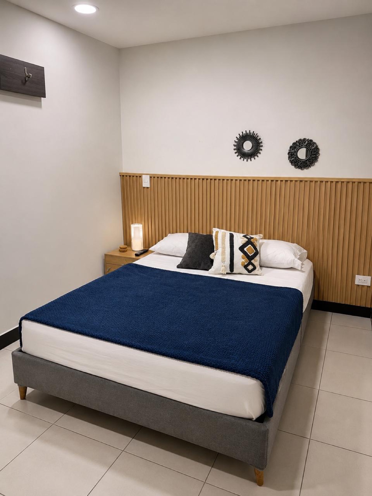 Double room with double bed, wood slat wall and air conditioning